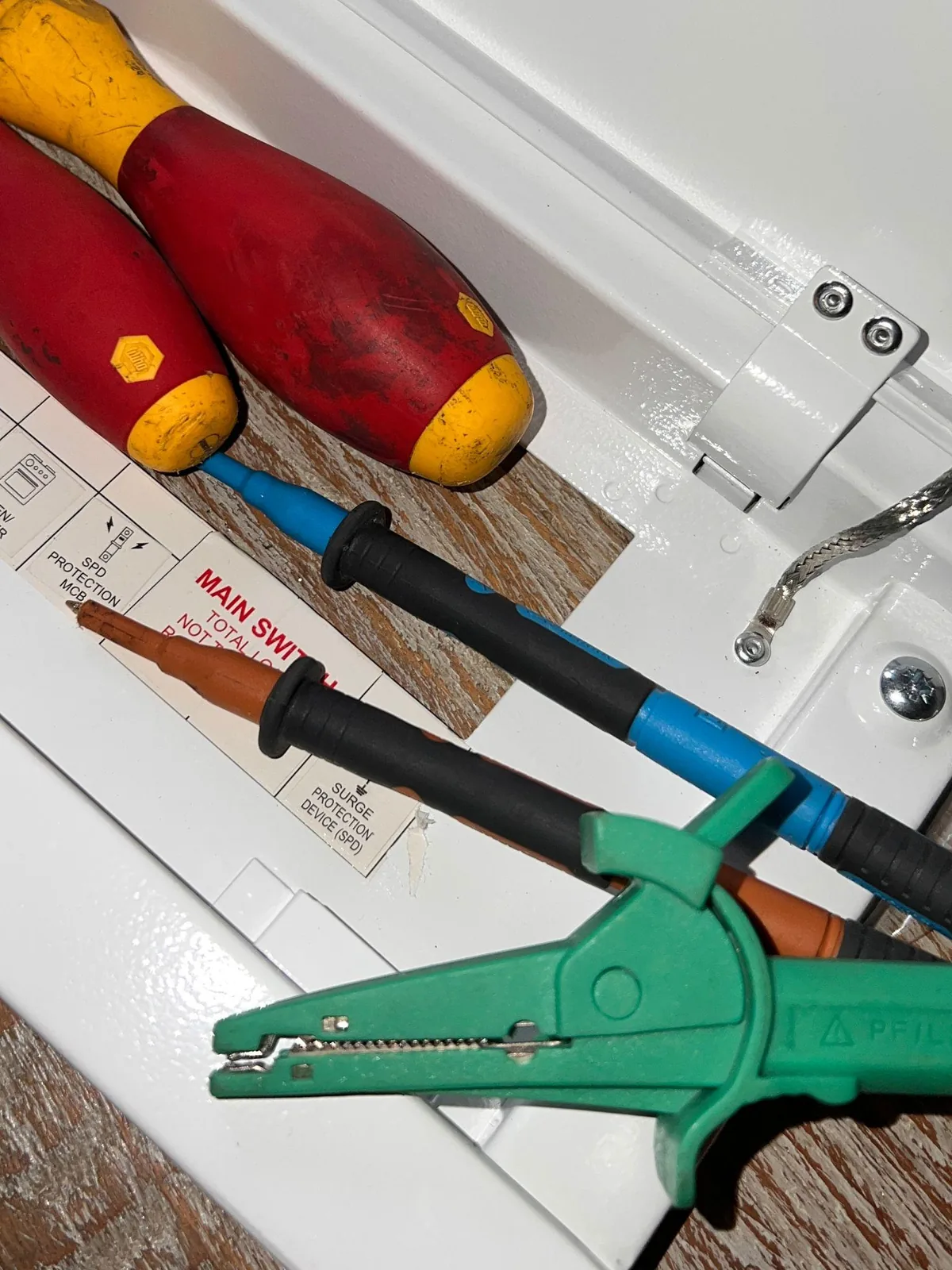 Electrician tools beside electrical equipment