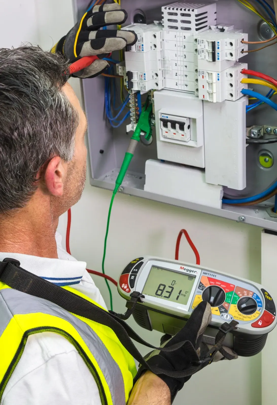 Electrician carrying out electrical inspection and testing